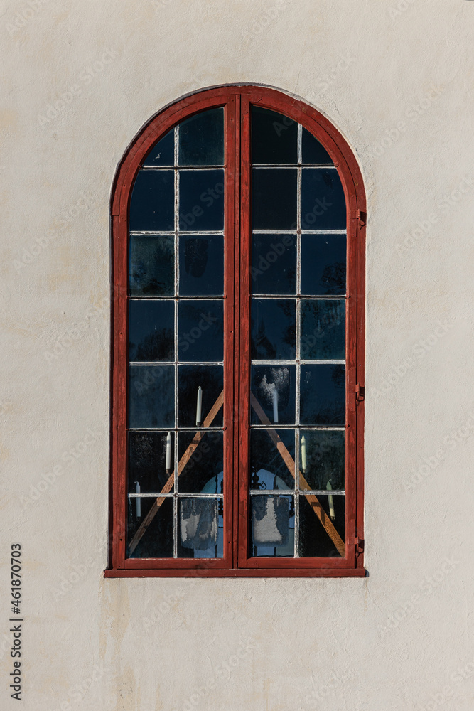 Obraz premium Red vaulted window on a white stone wall