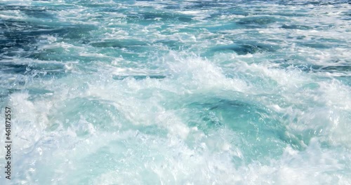 Great closeup up slow motion shot of the wake of a large ship in crystal clear waters
