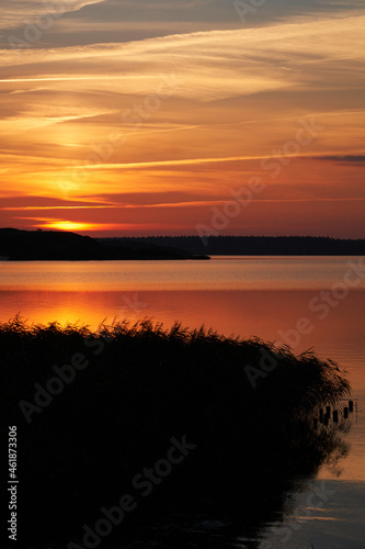 Colourful sunset at lake Flyndersoe in Denmark with the sky reflecting in the lake on a silent evening