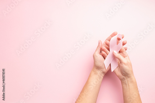 World Breast Cancer Awareness Month card with female s hands and pink ribbon..