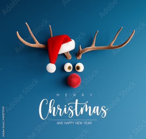 Photographie Reindeer with red nose and Santa hat on blue Christmas background 3D Rendering,