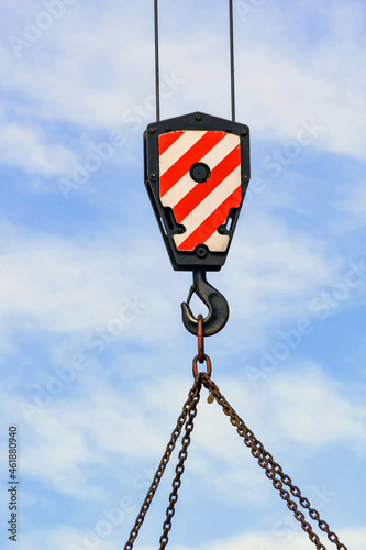 Close up view of a heavy hook and cable of a mobile crane with chains attached