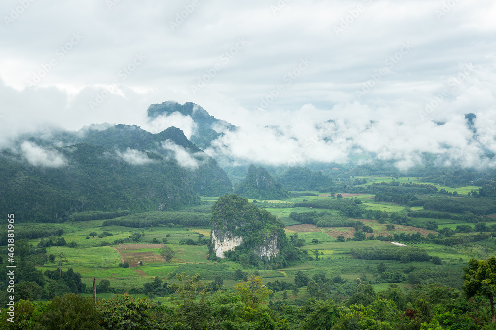 Obraz premium Unseen place in Thailand - a beautiful view of mountain range with greenery forest and misty environment in the morning time. Relaxation with nature view, scenic photo seen.