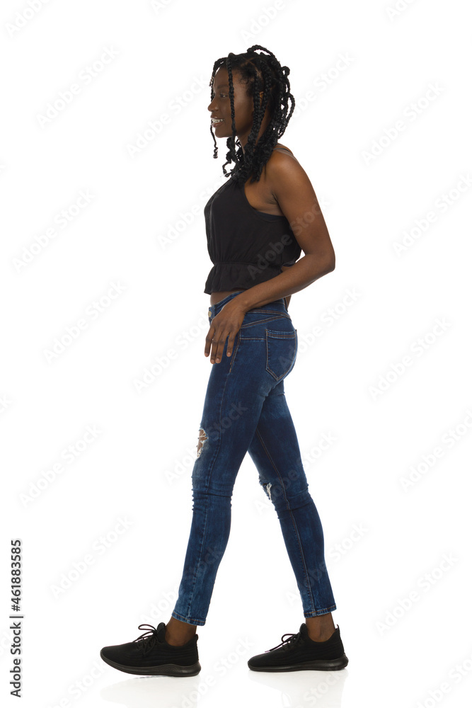 Confident African American Casual Woman Is Walking. Full Length, Side View. Confident African American Casual Woman Is Walking. Full Length, Side View.
