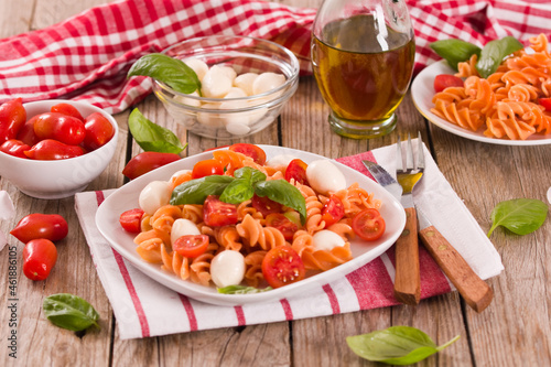 Fusilli pasta with cherry tomatoes and mozzarella cheese.