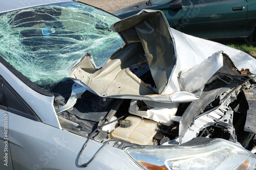 Closeup of a wrecked car after a head-on front end collision.