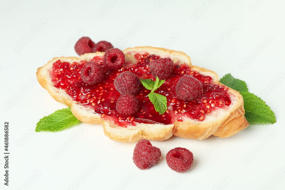 Croissant with raspberry jam on white background Croissant with raspberry jam on white background