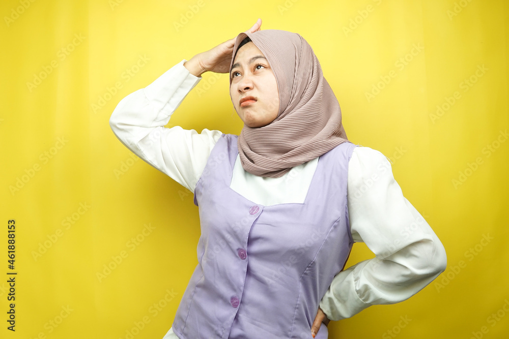 Beautiful young asian muslim woman stressed, dizzy, have a problem, feeling depressed, with hands holding head isolated on yellow background Beautiful young asian muslim woman stressed, dizzy, have a problem, feeling depressed, with hands holding head isolated on yellow background