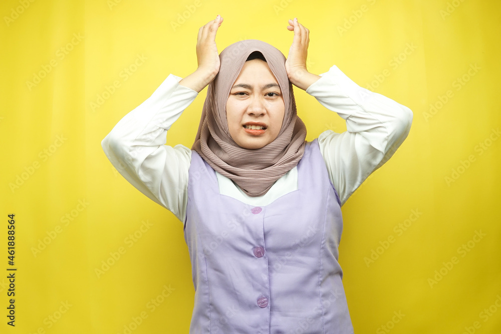 Beautiful young asian muslim woman stressed, shocked, dizzy, unhappy, many problems, want solution, with hands holding head isolated on yellow background Beautiful young asian muslim woman stressed, shocked, dizzy, unhappy, many problems, want solution, with hands holding head isolated on yellow background
