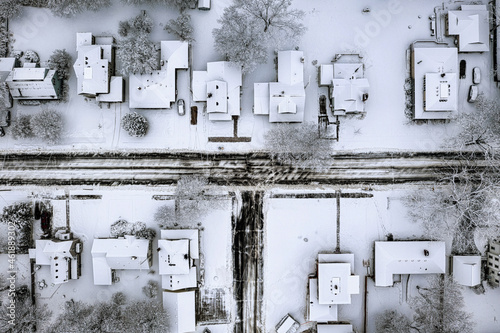 Aerial top-down view of houses covered with snow in winter season