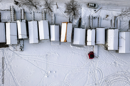 Aerial top-down view of houses covered with snow in winter season