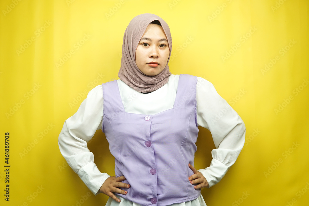 Beautiful young asian muslim woman pouting, angry, feeling annoyed, dissatisfied, uncomfortable, feeling bullied, lied to, looking at camera isolated on yellow background Beautiful young asian muslim woman pouting, angry, feeling annoyed, dissatisfied, uncomfortable, feeling bullied, lied to, looking at camera isolated on yellow background