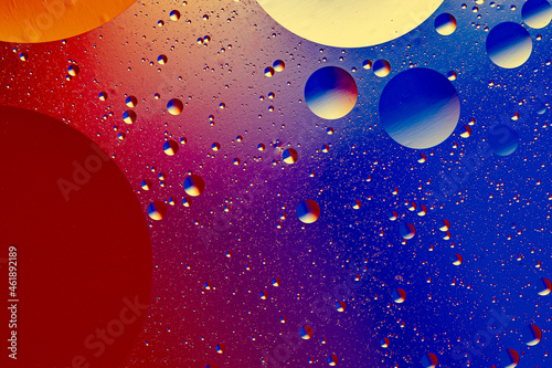 Abstract colorful background of oil circles. Oil in the water surface circles, water foam and oil bubbles.