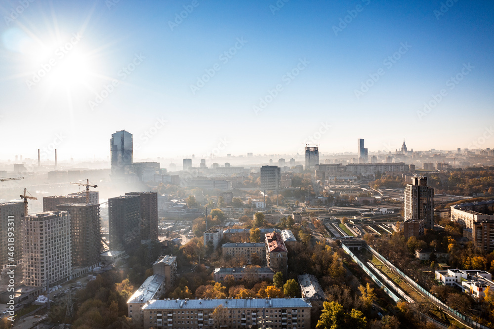 Obraz a panoramic view of the city business skyscrapers in the morning fog at sunrise filmed from a drone