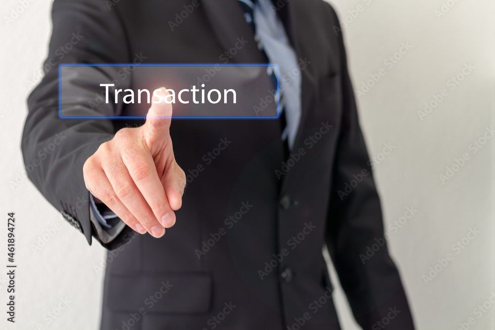 A Businessman is pressing a virtual button with the word Transaction A Businessman is pressing a virtual button with the word Transaction