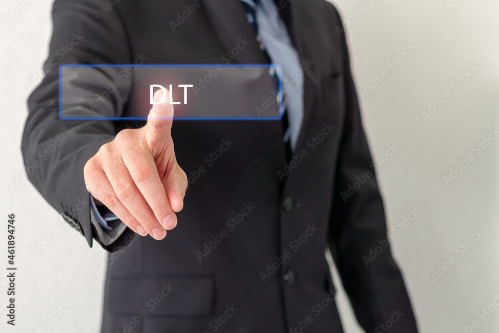 A Businessman is pressing a virtual button with the word DLT A Businessman is pressing a virtual button with the word DLT