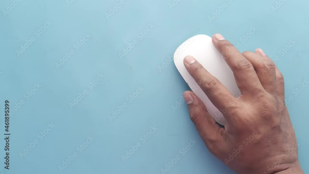 hand with computer mouse on blue background hand with computer mouse on blue background