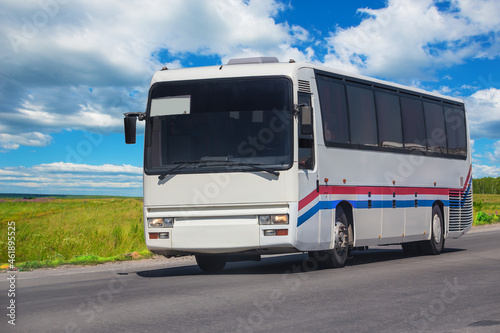 tourist bus moves along a suburban highway