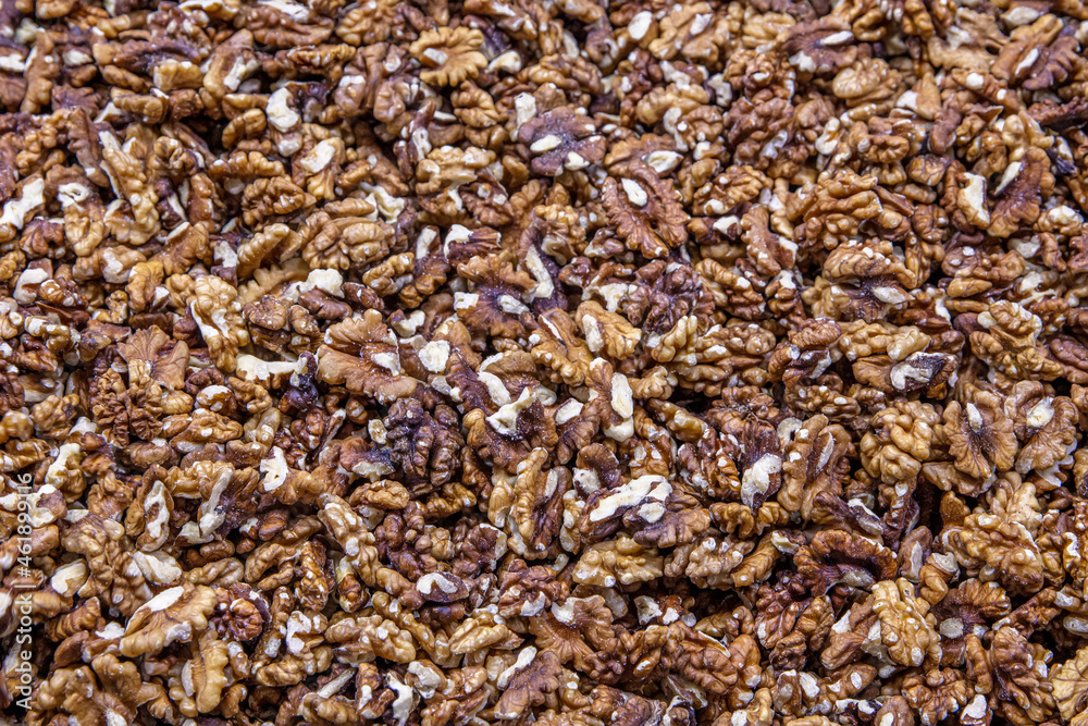 Walnuts are sorted for making baklava with walnuts. Walnuts without shells (filling the picture). Background of fresh walnuts.Walnuts background. Walnuts texture. Healthy food.