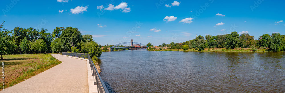 Panoramic view over old cathedral, stars bridge at historical downtown in Magdeburg at Elbe river, city park and new living houses, Germany, at blue summer sky and sunny day.