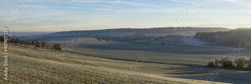 Panoramiv view at sunrise over hills in winter landscape in the Eifel, Germany photo