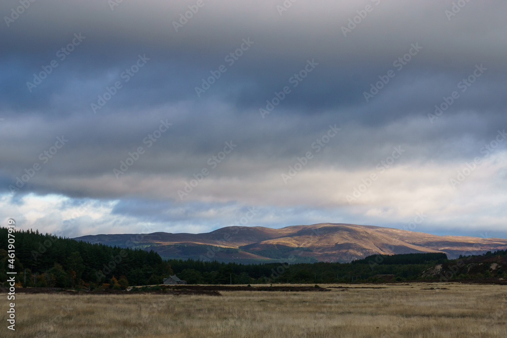 Morning in scottish landscape with mountain in golden sunlight in the Cairngorms National Park, Scottish Highlands, Scotland, UK