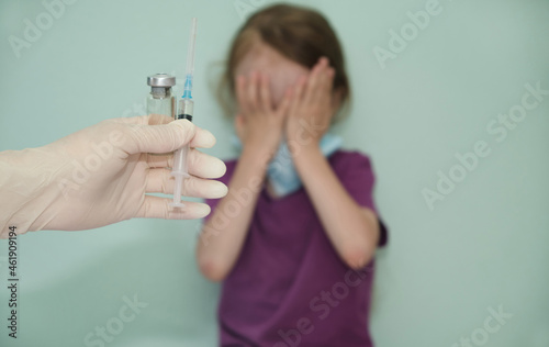 the child covered his face with his hands as a sign against the vaccine