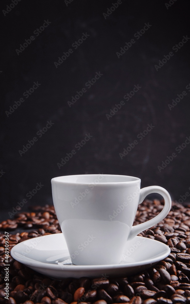 Cup with roasted coffee beans. Close up shot. cups on  table with scattered coffee beans. Soft focus.