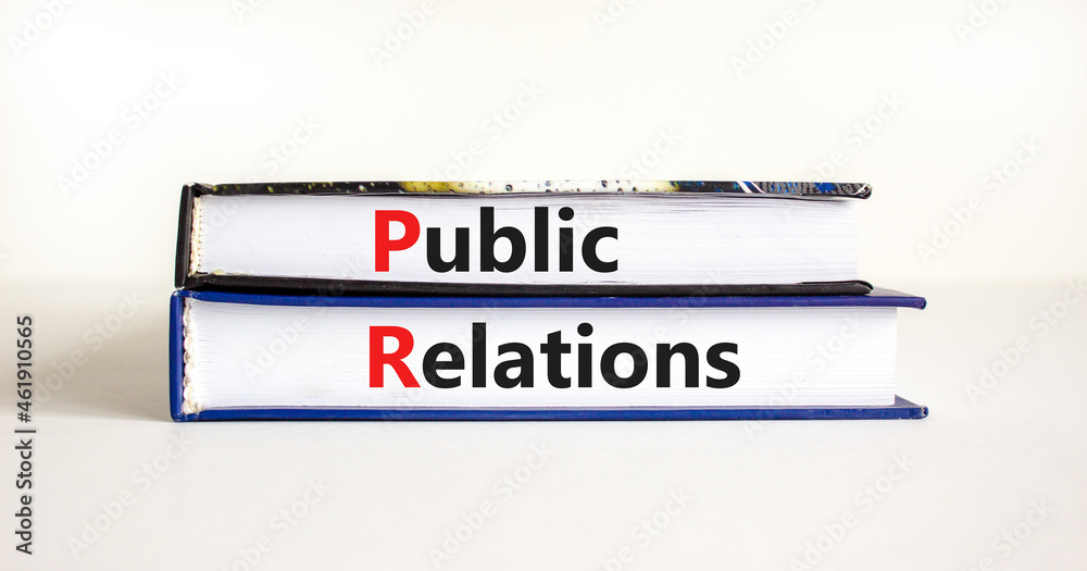 PR public relations symbol. Concept words 'PR, public relations' on books on white table, white background, copy space. Business and PR public relations concept.