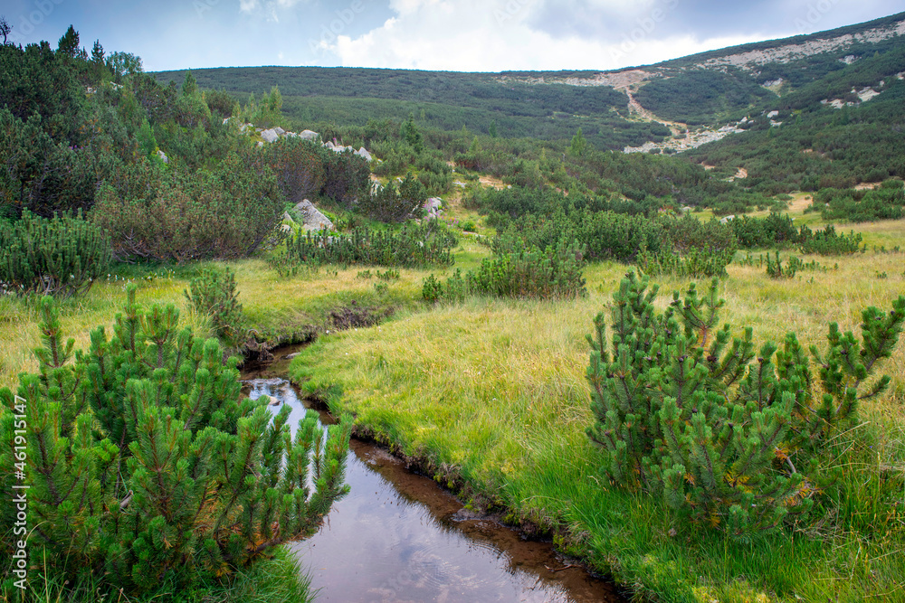 Obraz premium Bezbog hut in Pirin mountain Bulgaria with Bezbog lake on sunrise and sunset with rainbow