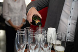 man filling champagne glass at celebration, close up