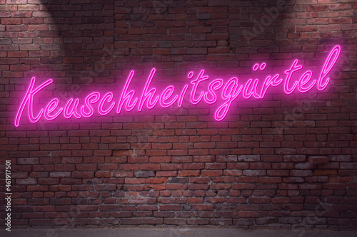 Neon BDSM Chastity devices (in german Keuschheitsgürtel) lettering on Brick Wall at night