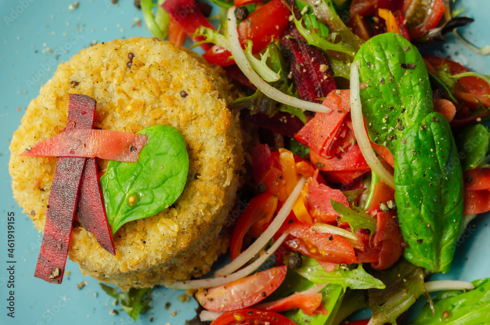 Ταπετσαρία Smoked haddock fishcake with melting cheddar sauce and mixed salad on the blue p