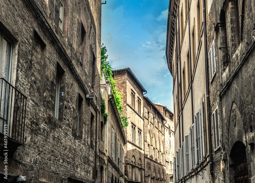 Ancient facades in a narrow street in Siena