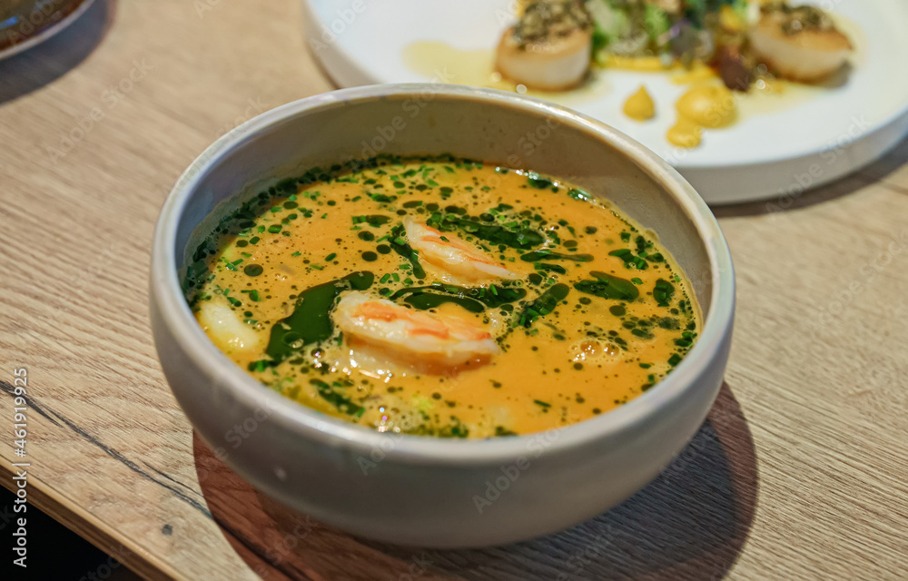 Seafood soup and scallops in the restaurant. Seafood soup and scallops in the restaurant.