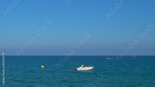 A sports boat floats in the sea.