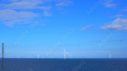 Windmills generating green energy at the sea