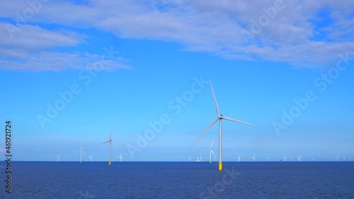 Windmills generating green energy at the sea