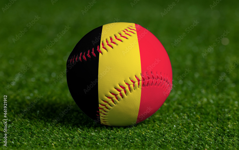 Baseball with Belgium flag on green grass background, close up