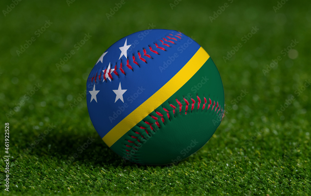 Baseball with Solomon Islands flag on green grass background, close up Baseball with Solomon Islands flag on green grass background, close up