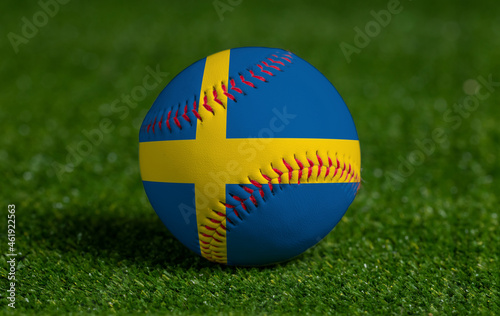 Baseball with Sweden flag on green grass background  close up
