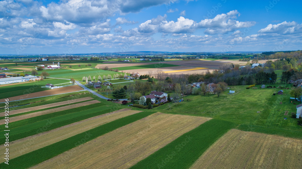 A Beautiful Aerial View of Farm Countryside with Patches of Colored Fields with White Fully Clouds and Shadows A Beautiful Aerial View of Farm Countryside with Patches of Colored Fields with White Fully Clouds and Shadows