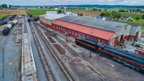 Aerial View of a Freight Yard With An Antique Steam Engine and Freight and Engine Shops