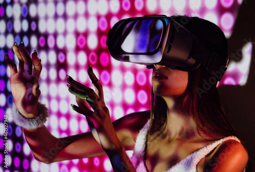 Woman in VR goggles in neon lights