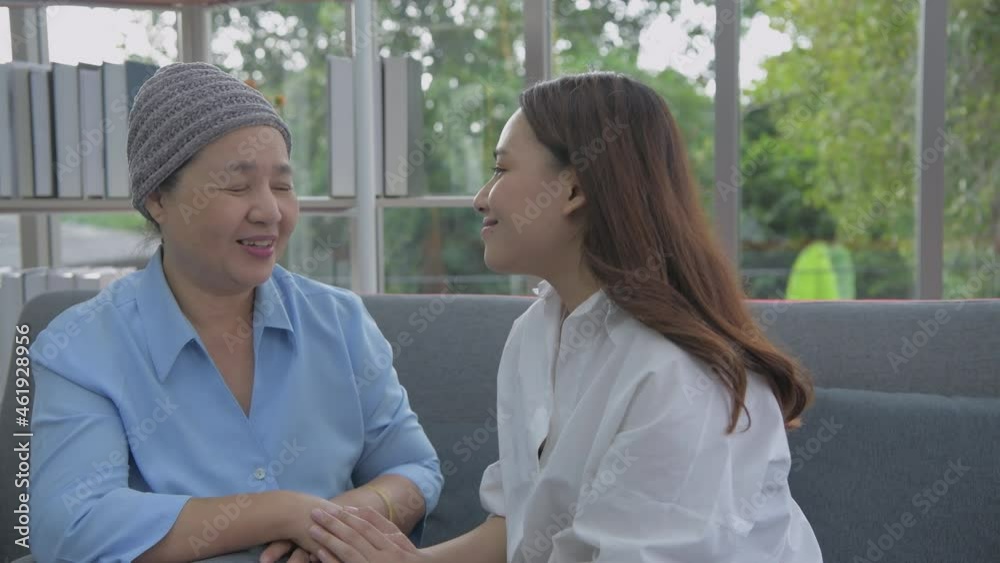 Family concept of 4k Resolution. Mother and daughter touching each other's heads in the living room. Family concept of 4k Resolution. Mother and daughter touching each other's heads in the living room.