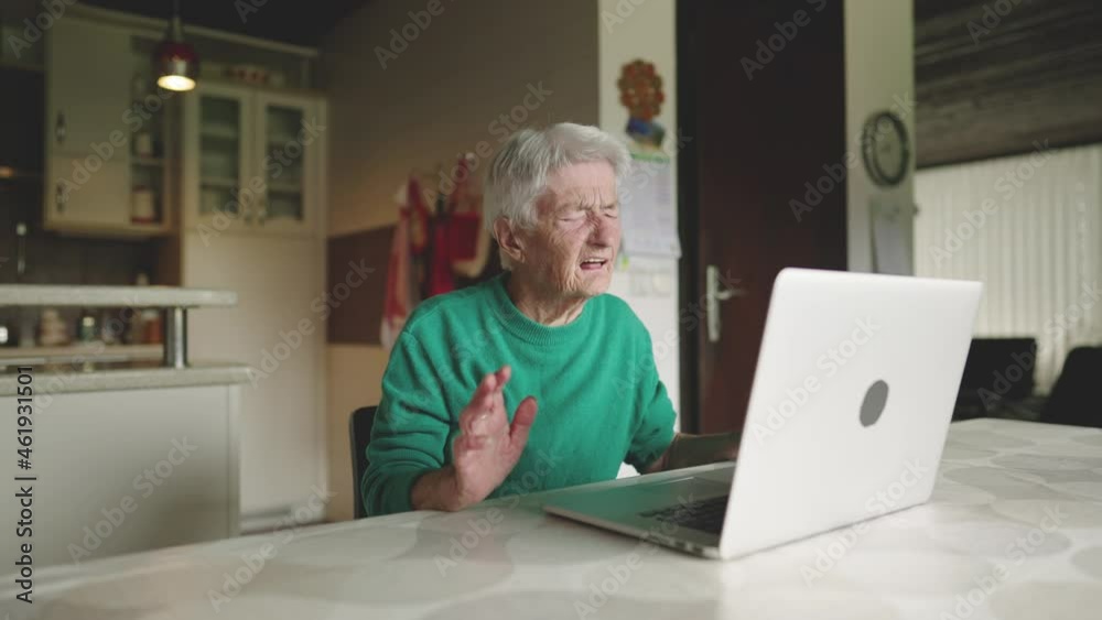 Old female behind the computer talking on a video call Old female behind the computer talking on a video call