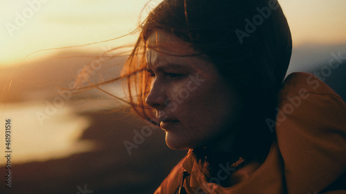 portrait of a woman at sunset in the mountains