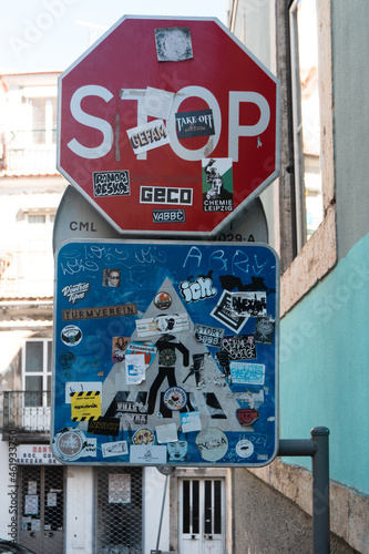 traffic signs stop and crosswalk filled with stickers