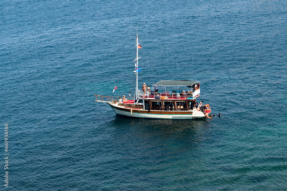 Kusadasi, Aydin, Turkey - August 23, 2021:Boat carrying scuba divers for touristic purposes. Kusadasi, Aydin, Turkey - August 23, 2021:Boat carrying scuba divers for touristic purposes.