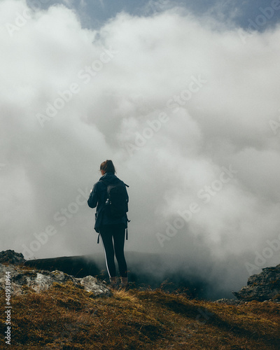 woman hiker in the mountains surrounded by clouds